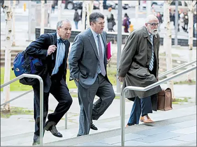  ?? Bloomberg/CHONA KASINGER ?? Attorneys for Huawei Technologi­es Co. arrive Thursday at federal court in Seattle, where they entered an innocent plea on behalf of the company.