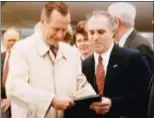  ?? PROVIDED BY WILLIAM STEINHAUS ?? President George H.W. Bush, left, signs school excuse notes for the children of then-Dutchess County Executive William Steinhaus, right, on Jan. 5, 1993, at Stewart Airport in New Windsor, N.Y.