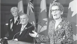  ?? FRANK GUNN/THE CANADIAN PRESS ?? Lt.-Gov. David Onley listens Thursday to premier-designate Kathleen Wynne, who said ‘Stay tuned,’ when asked about the makeup of her cabinet, to be sworn in on Feb. 11.