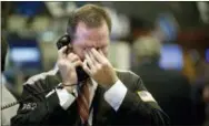  ?? THE ASSOCIATED PRESS ?? In this Sept. 17, 2008 file photo, trader Christophe­r Crotty rubs his eyes as he works on the floor of the New York Stock Exchange.
