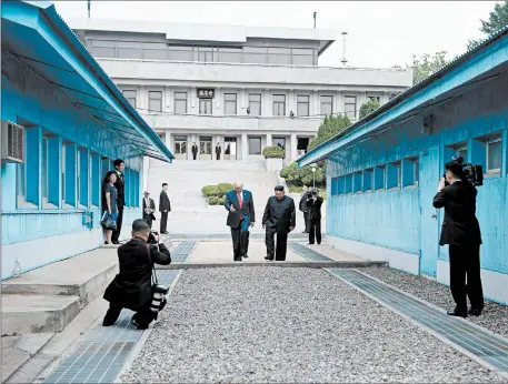  ?? BRENDAN SMIALOWSKI/GETTY-AFP ?? President Donald Trump, left, and North Korea leader Kim Jong Un stand north of the demarcatio­n line that separates North and South Korea on Sunday.