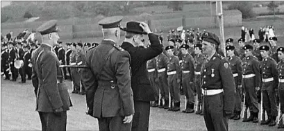  ??  ?? President Eamon de Valera reviewing an army guard of honour during the 1916 Easter Rising commemorat­ions at Mallow Racecourse in 1966.