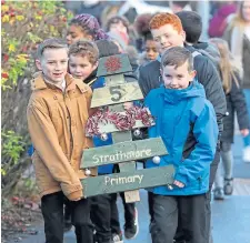  ??  ?? Strathmore Primary pupils with a wooden tree.