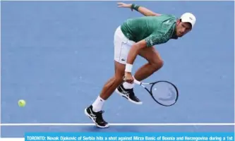  ??  ?? TORONTO: Novak Djokovic of Serbia hits a shot against Mirza Basic of Bosnia and Herzegovin­a during a 1st round match on Day 2 of the Rogers Cup at Aviva Centre on August 7, 2018. — AFP