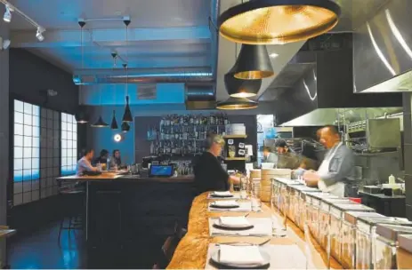  ?? Hyoung Chang, The Denver Post ?? The best seat in the house is one of the five stools fronting the narrow open kitchen.