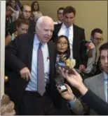  ?? CLIFF OWEN — ASSOCIATED PRESS ?? Sen. John McCain, R-Ariz., is pursued by reporters early Friday after casting the decisive ‘no’ vote in the Senate’s Obamacare repeal effort.