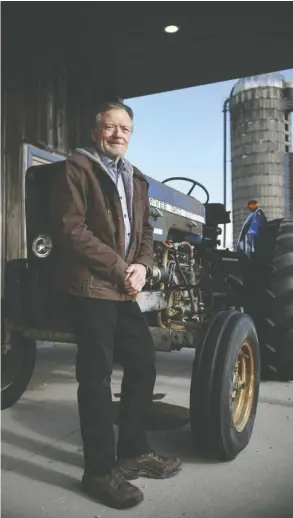  ?? Julian Gavaghan ?? Phil McKee, whose father Russell McKee and uncle Gerald, ran the taffy display for 36 years, stands by an old McKee tractor at his farm near Glen Allan.