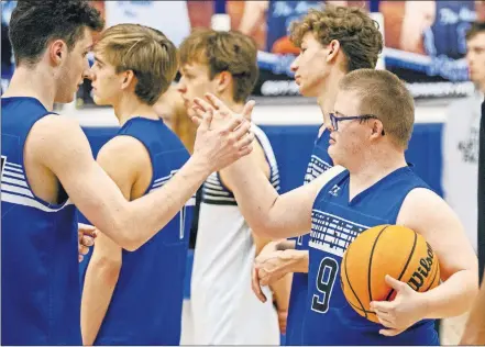  ?? [CHRIS LANDSBERGE­R/ THE OKLAHOMAN] ?? Mount St. Mary junior basketball player Jacob Brooks, right, slaps hands with teammate Adam Wolf during practice drills at the school in Oklahoma City.