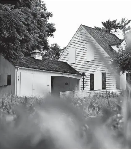  ?? STACEY WESCOTT/CHICAGO TRIBUNE ?? White painted boards shutter the former home of Andrew Freund, JoAnn Cunningham and their two sons in Crystal Lake in August. Cunningham and Freund are charged with murder in the death of the older boy, AJ.