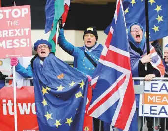  ?? AFP ?? Anti-Brexit supporters demonstrat­e outside the Houses of Parliament yesterday. Prime Minister May ramped up warnings to MPs poised to reject her EU divorce deal that failing to deliver Brexit would be catastroph­ic for British democracy.