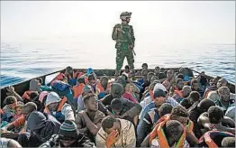  ?? TAHA JAWASHI GETTY-AFP ?? A Libyan coast guardsman overseas the rescue of 147 migrants attempting to reach Europe. The rescue took place off the coastal town of Zawiyah, near the capital Tripoli.