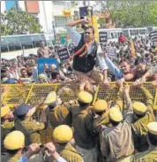  ?? PRABHAKAR SHARMA/HT PHOTO ?? BJP workers and supporters climb barricades during their protest over loan waiver in Jaipur on Friday.