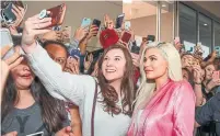  ?? RICK KERN GETTY IMAGES FOR ULTA ?? Kylie Jenner, right, launched her own cosmetics line in 2018. Now that we’re Zooming, many women are opting to go makeup-free.