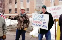  ??  ?? BURNS: Protesters stand in front of the Harney County Courthouse. — AP