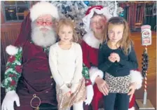  ?? | PROVIDED PHOTO ?? Taryn (left) and Maquinna (right) Peglow with Santa and Mrs. Claus in Waconia, Minn., at breakfast with Santa at Lola’s Lakehouse.