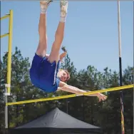 ?? Westside Eagle Observer/MIKE ECKELS ?? Jaksyn McAdams pushes his pole away as he clears the bar during the pole vault which was just one of the 18 boys’ events of the 2022 2A West district track meet in Eureka Springs on April 27. McAdams finished in fifth place with a vault of eight feet, six inches.