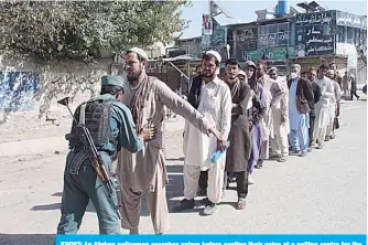  ?? —AFP ?? KHOST: An Afghan policeman searches voters before casting their votes at a polling centre for the country’s legislativ­e election in Khost Province yesterday.