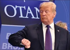  ?? The Associated Press ?? U.S. President Donald Trump checks the time prior to a dinner of leaders at the Art and History Museum in Brussels on Wednesday.