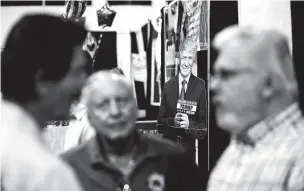  ?? SCOTT MCINTYRE/NEW YORK TIMES ?? A cardboard cutout of Donald Trump looms at a July rally in Sarasota, Fla. To the dismay of party leaders, the healthy economy and Trump have become countervai­ling forces.