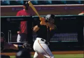  ?? MATT YORK — THE ASSOCIATED PRESS ?? The San Francisco Giants’ LaMonte Wade Jr. hits against the Arizona Diamondbac­ks during the second inning of a spring training game Monday in Scottsdale, Ariz.