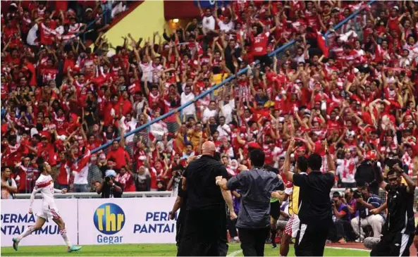  ??  ?? The winner: Kelantan’s Indra Putra Mahayuddin (left) celebrates his winning goal against Armed Forces in the Malaysia Cup final at the Shah Alam Stadium last night. Forces won 3-2 after extra -time.