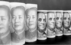  ??  ?? US$100 dollar banknotes and Chinese 100 yuan banknotes are seen in this photo illustrati­on. US President Donald Trump set the tone for a tense first meeting with Chinese President Xi Jinping next week by tweeting that the United States could no longer...