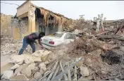  ?? AP ?? A man cleans up the rubble after an earthquake at Sayeh Khosh village in Hormozgan province, Iran, on Saturday.