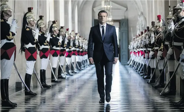  ?? ETIENNE LAURENT / AFP / GETTY IMAGES ?? French President Emmanuel Macron walks through the Busts Gallery at Versailles Palace, just outside of Paris, on his way to address a special congress of both houses of parliament, an event normally reserved for times of crisis or constituti­onal reform.