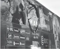  ?? Associated Press ?? n A window of Dortmund’s team bus is damaged Tuesday after an explosion before the Champions League quarterfin­al soccer match between Borussia Dortmund and AS Monaco in Dortmund, western Germany.