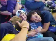  ?? THE ASSOCIATED PRESS ?? Dancers for Penn State, Mont Alto, Taylor Zeiders and Erica Newton, hug after completing the 46 hours in the Penn State IFC/Panhelleni­c Dance Marathon on Sunday in State College.