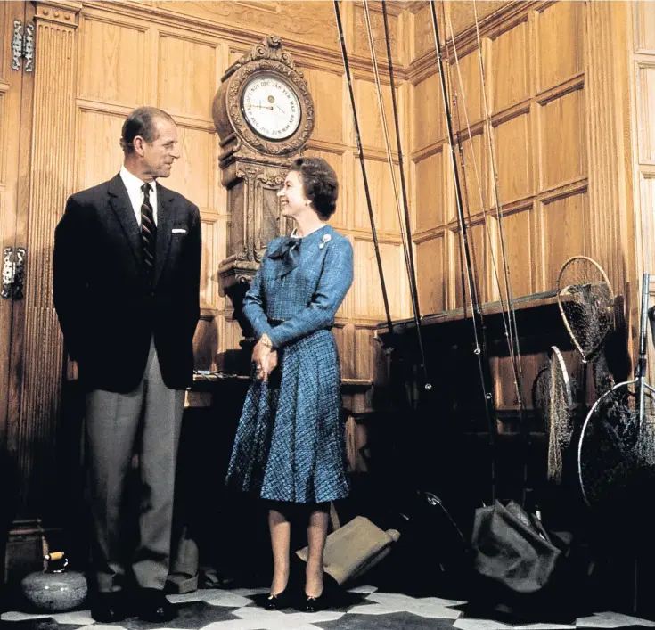  ??  ?? The duke and the Queen admire the wood-panelled splendour of Balmoral Castle in 1976.