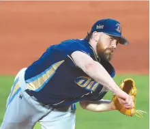  ?? Yonhap ?? Eric Hacker of the NC Dinos throws a pitch against the Lotte Giants in Game 5 of their first round Korea Baseball Organizati­on postseason series at Sajik Stadium in Busan, Sunday.