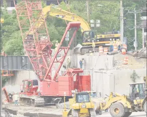  ?? Matthew Brown / Hearst Connecticu­t Media ?? Work crews work to remove a dilapidate­d Route 1 bridge on June 1 that spans I-95 at exit 9 in Stamford making way for new spans of prefabrica­ted bridge.