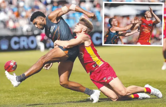  ?? Pictures: Phil Hillyard, Dylan Burns/AFL Photos via Getty Images ?? GWS Giant Callum Brown gets his kick away in the tackle of Gold Coast’s Bodhi Uwland during the teams’ Gather Round clash at Mount Barker on Sunday. INSET: Giant Kieren Briggs and Sun Ethan Read compete in a ruck contest.