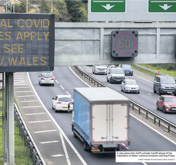  ?? CHRIS FAIRWEATHE­R/HUW EVANS AGENCY ?? A sign above the A470 outside Cardiff ahead of the imposition of Wales’ national lockdown starting Friday