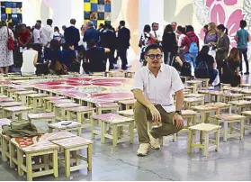  ??  ?? Michael Lin surrounded by his chair-puzzle hybrid, Untitled Gathering