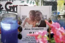  ?? PHOTO/JAE C. HONG ?? In this Aug. 5, 2013, file photo, a card showing a photo of Italian newlyweds Alice Gruppioni (left) and her husband Christian Casadei, is placed on a makeshift memorial for Gruppioni along Ocean Front Walk at Venice Beach in Los Angeles. AP