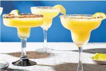  ??  ?? Take the classic blended margarita and give it a tropical spin with fresh or frozen mango.