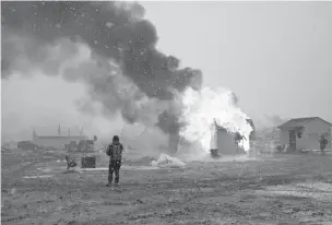  ??  ?? Structures burn Wednesday at the Oceti Sakowin protest camp near Cannon Ball, N.D. While most Dakota Access pipeline protesters cleared out by the government’s deadline to leave, some remained Wednesday evening.