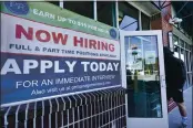  ?? ELISE AMENDOLA — THE ASSOCIATED PRESS ?? A man walks into a restaurant displaying a “Now Hiring” sign in Salem, N.H., on Thursday.