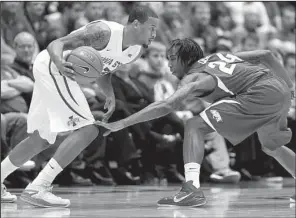  ?? AP/CHARLIE NEIBERGALL ?? Iowa State guard Bryce Dejean-Jones (left) drives past Arkansas guard Michael Qualls during the first half of Thursday’s game in Ames, Iowa. Dejean-Jones led the Cyclones with 27 points.