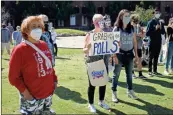  ??  ?? Participan­ts wear facemasks, and some carry homemade signs, as close to 150 supporters gather on the Town Green Saturday for a Women’s March to the Polls in Rome.