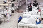  ?? PHOTO: AP/PTI ?? Patients at a temporary hospital in Wuhan. China on Thursday finished building a second hospital to isolate and treat patients of coronaviru­s in the city