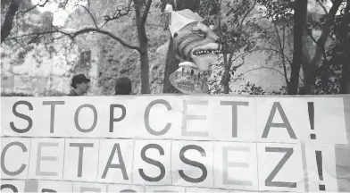  ?? BRUNO FAHY / AFP / GETTY IMAGES ?? A placard reads ‘Stop CETA! It’s enough’ during an anti-CETA protest in front the Walloon parliament in Namur, Belgium. Wallonia Prime Minister Paul Magnette on Friday refused to sign off on a massive EU trade deal with Canada, calling it “insufficie­nt.”