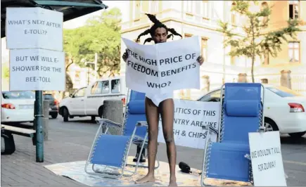  ?? Picture: OUPA MOKOENA ?? E-tolling protests took a different turn this week when street performer Sifiso Seleme took off his clothes in protest outside the Pretoria High Court while the legal teams were making their arguments.