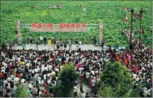  ?? PROVIDED TO CHINA DAILY ?? Rural residents gather outside the cultural auditorium of Tantou village in Kaihua county, Zhejiang province.