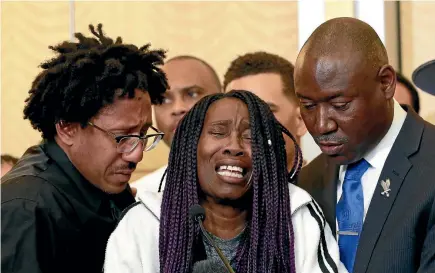  ?? PHOTO: AP ?? A tearful Sequita Thompson, centre, discusses the shooting of her grandson, Stephon Clark, during a news conference yesterday in Sacramento, California. Thompson was accompanie­d by Clark’s uncle, Kurtis Gordon, left, and attorney Ben Crump, right.