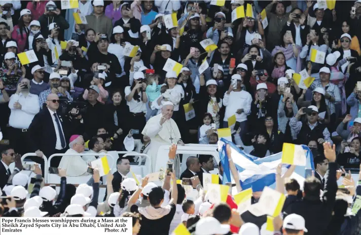  ??  ?? Pope Francis blesses worshipper­s during a Mass at the Sheikh Zayed Sports City in Abu Dhabi, United Arab Emirates Photo: AP