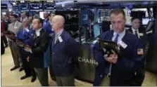  ?? RICHARD DREW — THE ASSOCIATED PRESS ?? Traders on the floor of the New York Stock Exchange, Tuesday observe a moment of silence in the wake of the attack in Manchester, England.