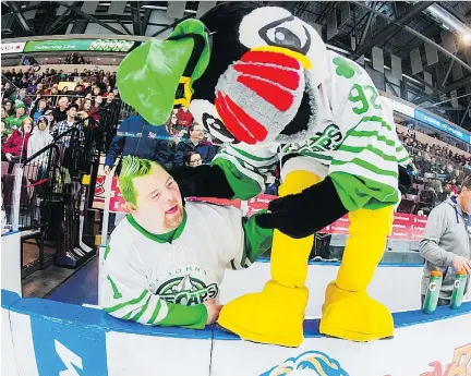  ?? COLIN PEDDLE/ST. JOHN’S ICECAPS ?? St. John’s IceCaps super fan Andrew Abbott jokes around with team mascot Buddy the Puffin last season. Andrew and his parents have flown to Montreal from St. John’s for this weekend’s Laval Rocket games and he will be on the bench during the pregame...